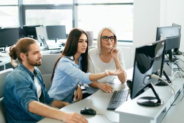 IT office. People Working At Open Workplace