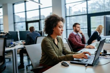 Woman in office focused on her work
