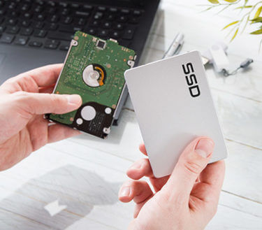 Person holding two drives