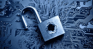 opened, breached padlock with bullet hole on top of data circuit board