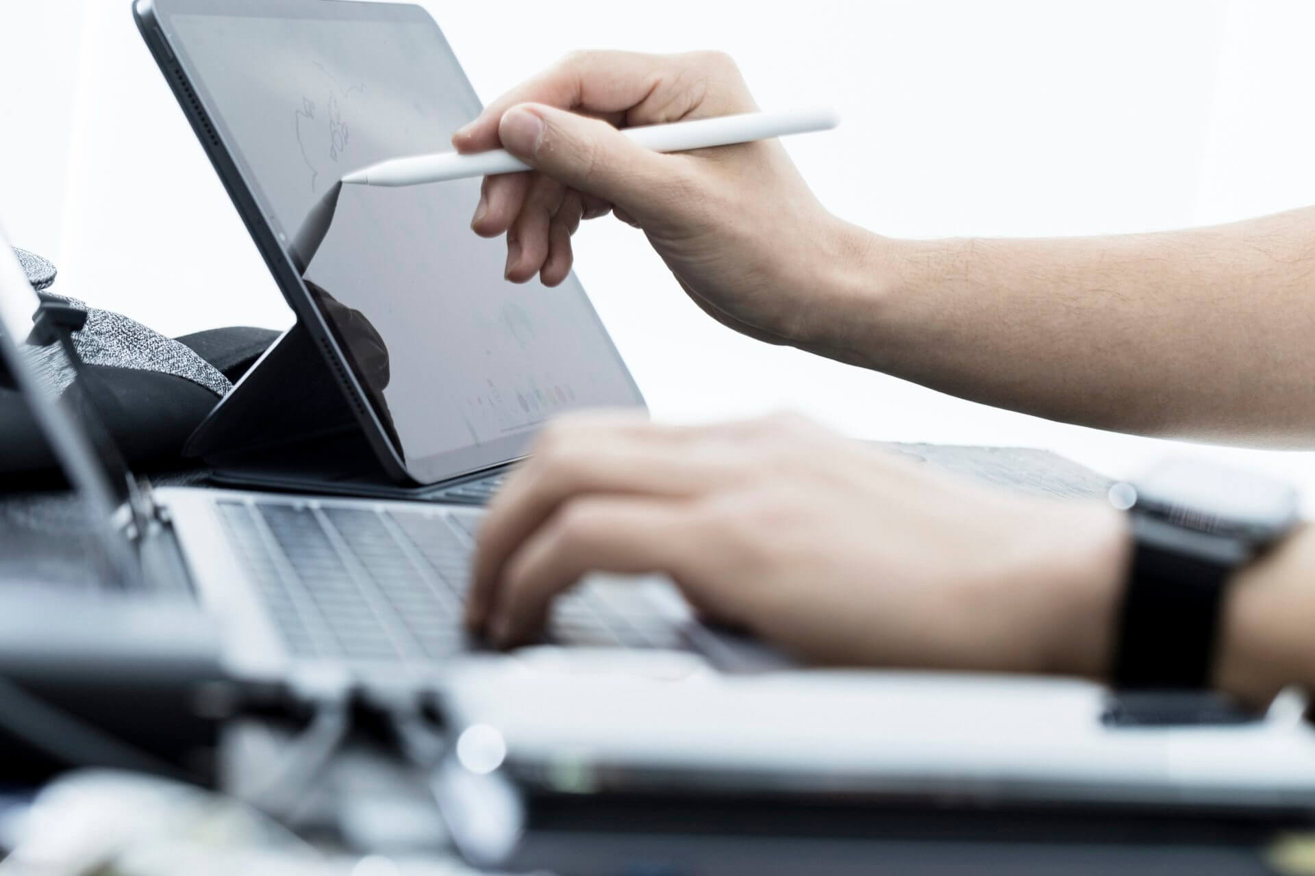 Hands using modern technology devices: wearables, desktop, laptop, phone