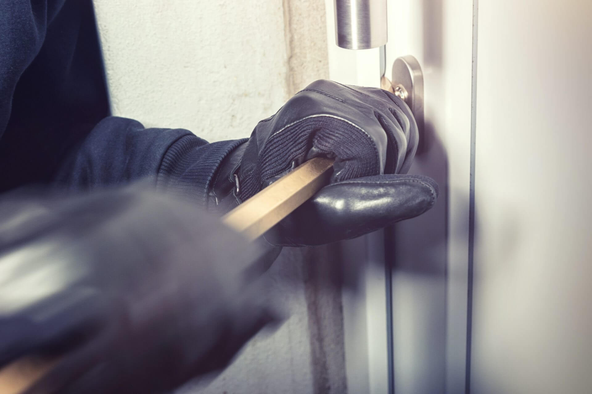 A person tries to break into a door.