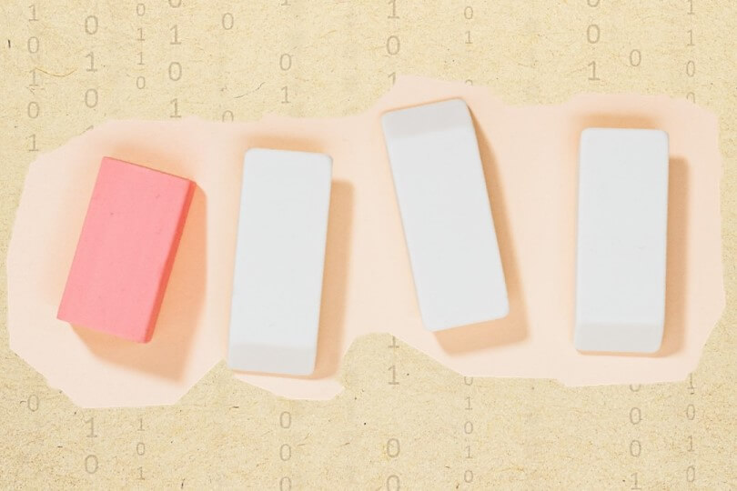 various rubber erasers on paper with typewritten binary code representing data wiping and erasing standards